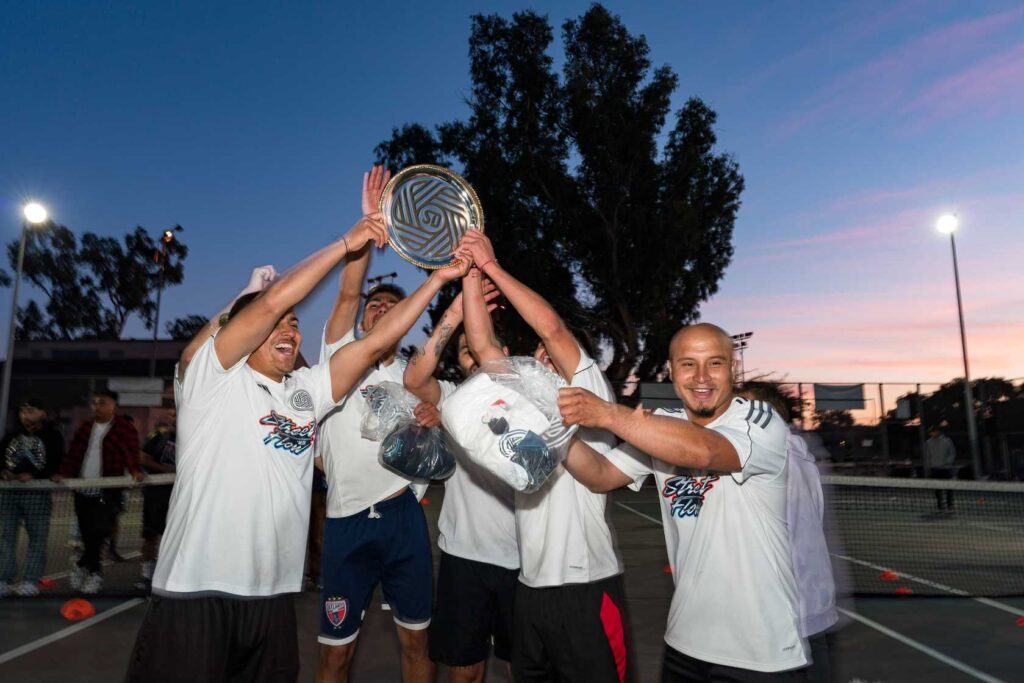 a group of people raising a trophy