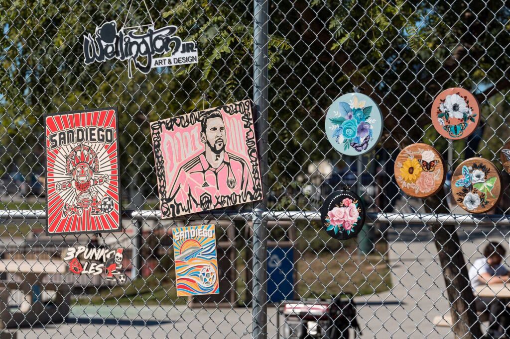 art pieces placed on a metal fence 