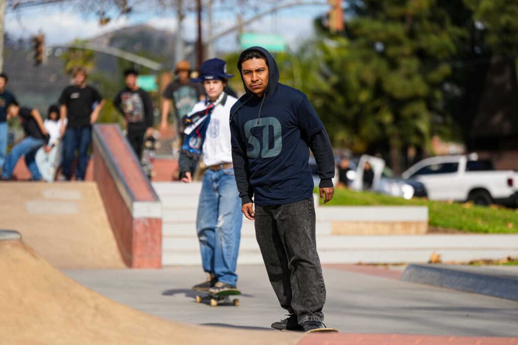 two men riding skateboards
