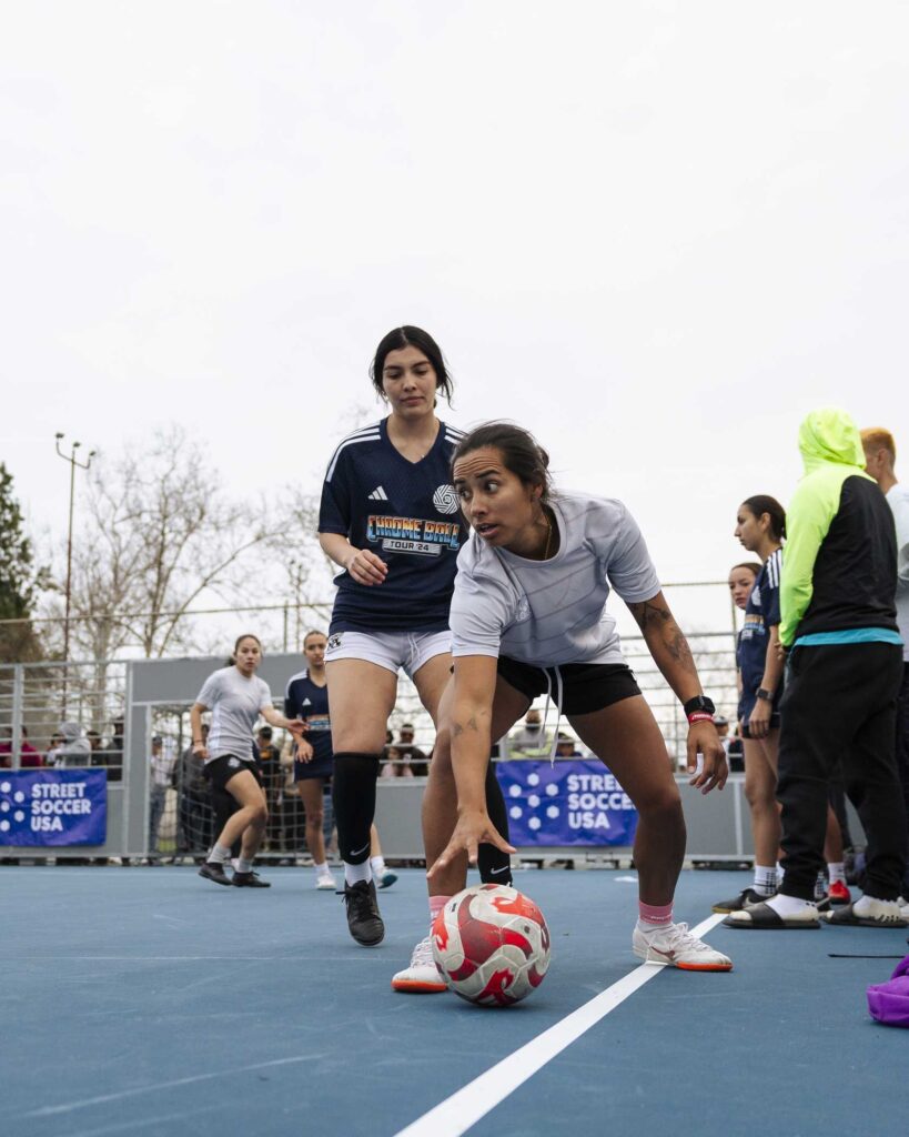 a group of women playing football on a blue court