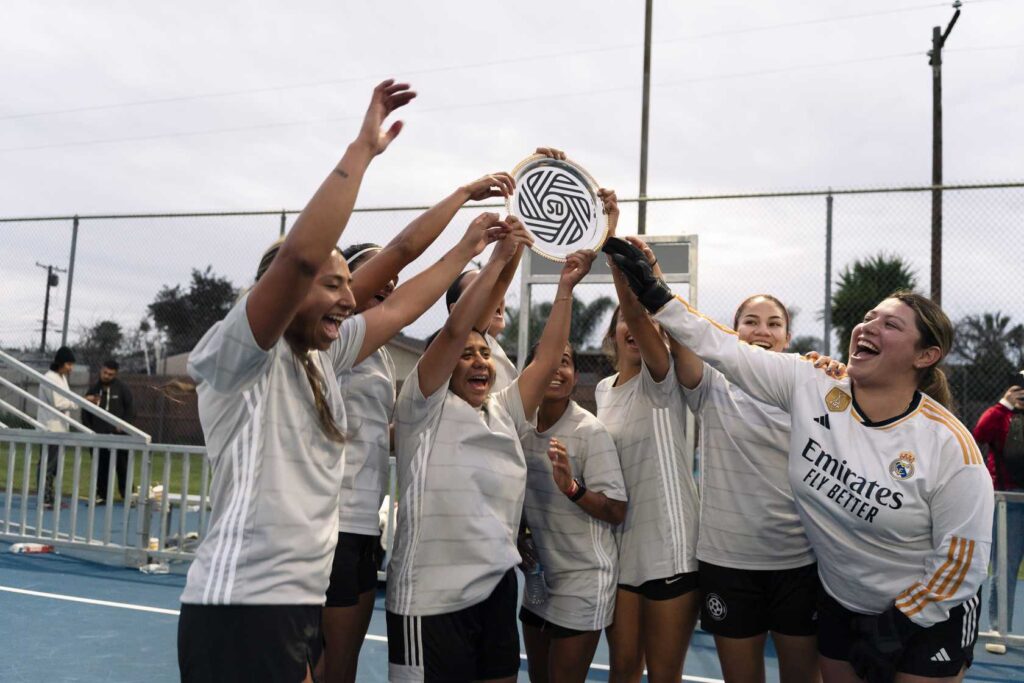 a group of women holding a trophy